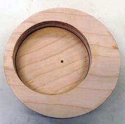 Mount the plywood blank between centers using the small hole for centering, and turn to the outer 7" diameter mark. 3.