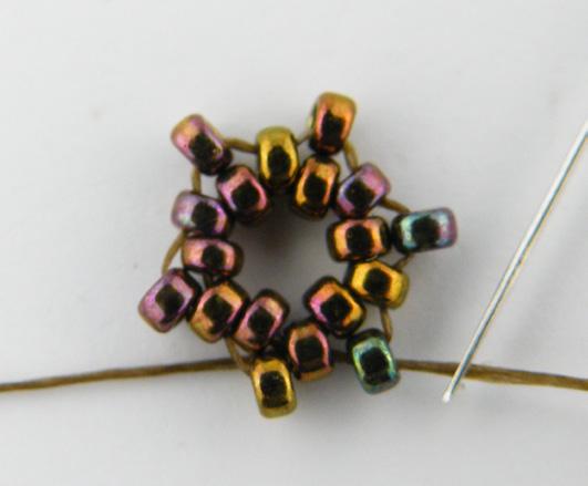 Row 10: String 1 size 11 and pass through the next size 11 bead. String 2 size 15 beads and pass through the third bead of the set of 5 size 15 beads from Row 9.