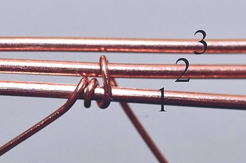Coil the weaving wire once or twice around the bottom base wire (or base wire 1) at
