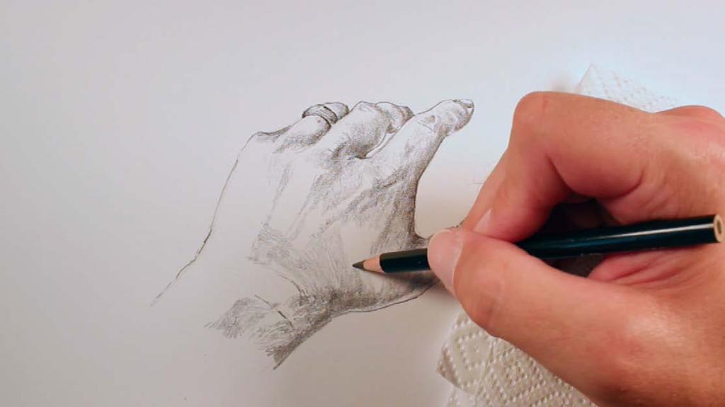A paper towel or scrap piece of paper is placed under the palm of the hand during this process of the drawing.