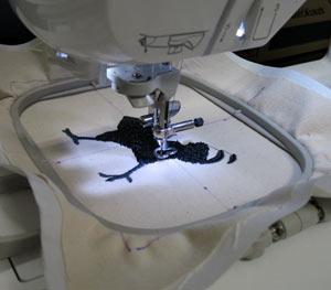 Attach the hoop to the machine, load the design, align the needle directly over the