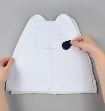 You can do this by setting your paper pattern on top of the fabric piece (right sides up), align the eye piece on top where the placement markings are,