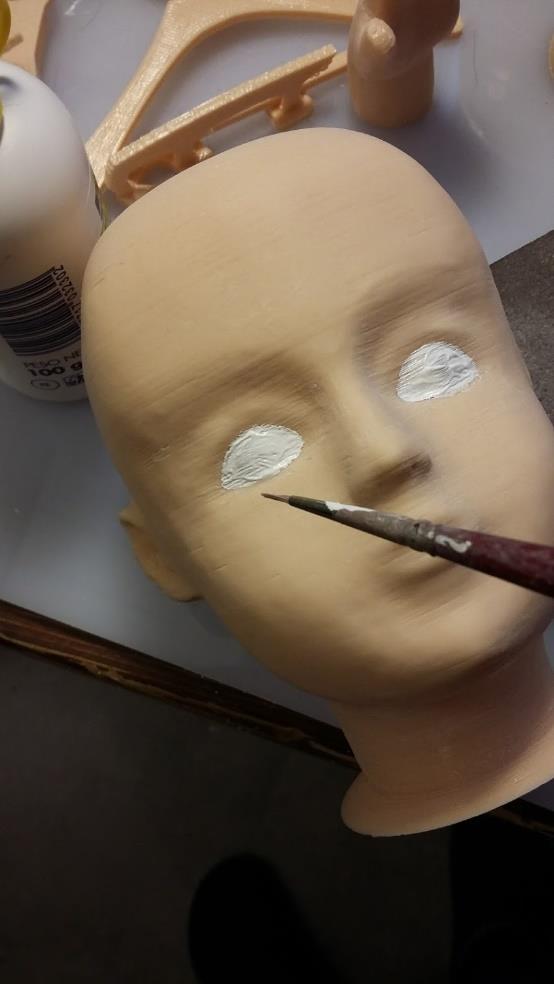 Now you can proceed to paint the facial details: