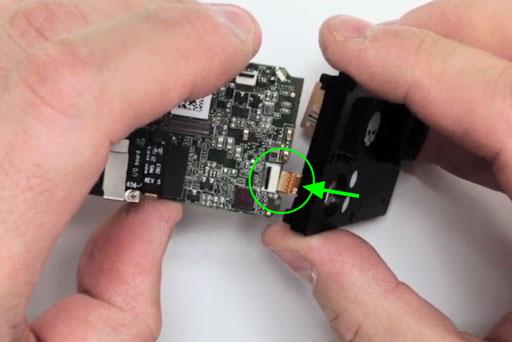 Carefully move the flexible PCB jumper into the empty area where the wide angle lens assembly resided and match the