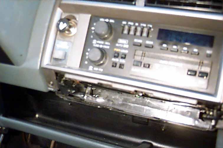 STEP 2: Pull out the ashtray to its extended position. Locate and remove one (1) phillips screw at the bottom left corner under the plastic dash panel.