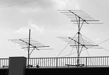 Figure 1. A photo of our interferometer directionfinding system consisting of three eight-element Yagi antennas installed on the roof of our building.