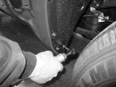16 17 Using a socket wrench with a 10mm socket, remove lower screw from front of