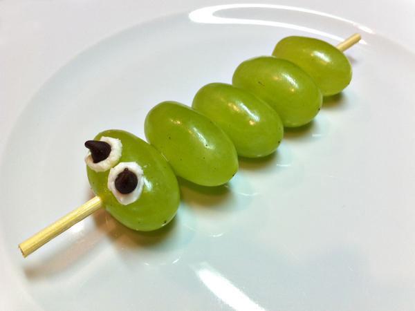 Edible Caterpillars Skewer Grapes White frosting Mini chocolate chips Scissors Cut the skewers in half