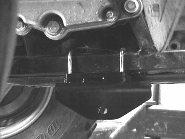 Position the square U-Bolts on the frame tube in the notched area of the skid pan. Install the spacer plate on the U-Bolts and then install the frame mount.