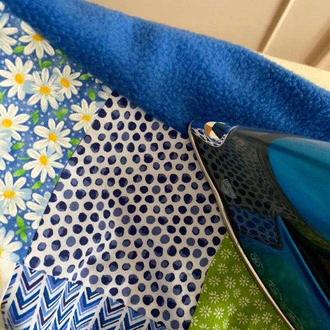 Cut the extra fabric from the corners. Turn the blanket right side out through the opening, making sure the corners are pushed out.