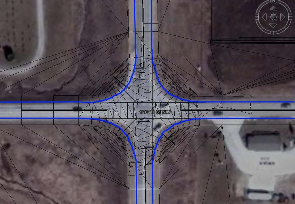 aerial image of the intersection in the real world with black and blue lines representing the virtual world laid on top of it.
