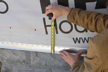 This will ensure you have a consistent distance from the soffit line to the starter strip. To establish a level plane, attach a string line from nail to nail and work your way around the house.