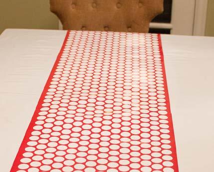 Recreate This Look Step 1: Start with a white table cloth and layer on the Red Chevron & Polka Dot Table Runner.