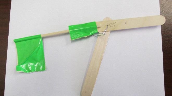 Fold a piece of duct tape over one end of the dowel rod then use duct tape to attach the dowel rod to the short end shown in Fig. 3.