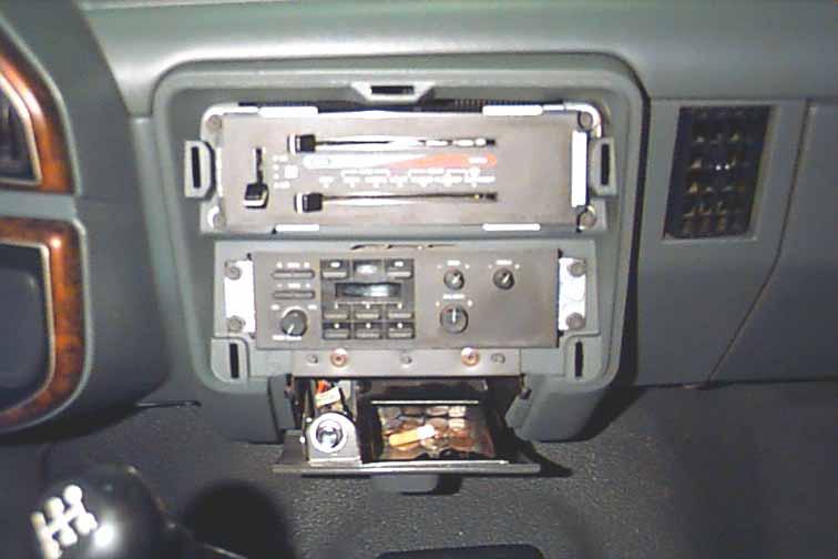 With your hands, pull the top of the plastic dash panel until it unsnaps from the dash. Once removed, the radio and screws which secure the radio should be visible.