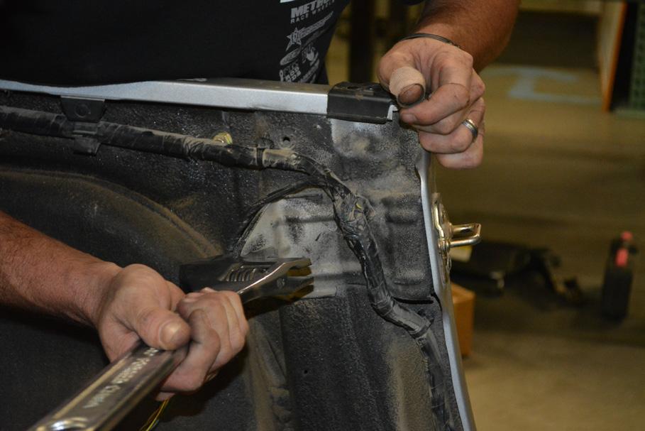 Use a large crescent wrench to bend the sheet metal roll bar brackets back into place, as they were likely bent