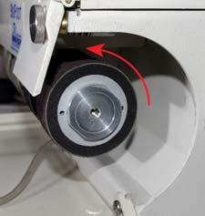 Using Four Inch Diameter Attachments: The flap at the upper right corner of your machine can be opened by first unscrewing the thumb-screw that holds it in place and then pulling the flap towards you.