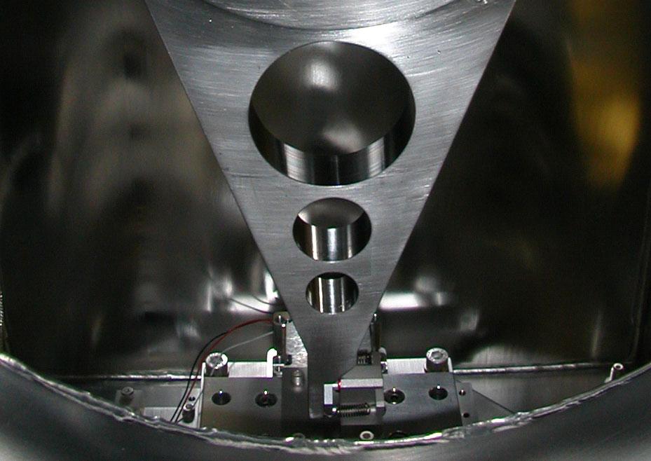 Using a hardened ruby ball (7) as a precision contact point, the sine-bar arm is driven by a commercial UHV-compatible ceramic-motor-driven linear positioning stage (8) that has 10 nanometer