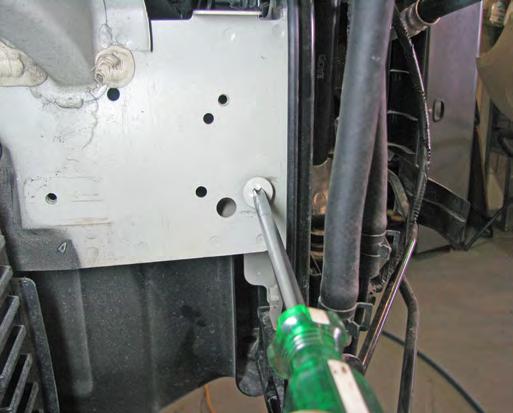 On the passenger side, using a 10MM socket remove the two bolts