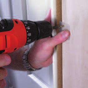 Offer the doorset into the wall opening, plastic bracket side first, ensuring plastic brackets are extended.