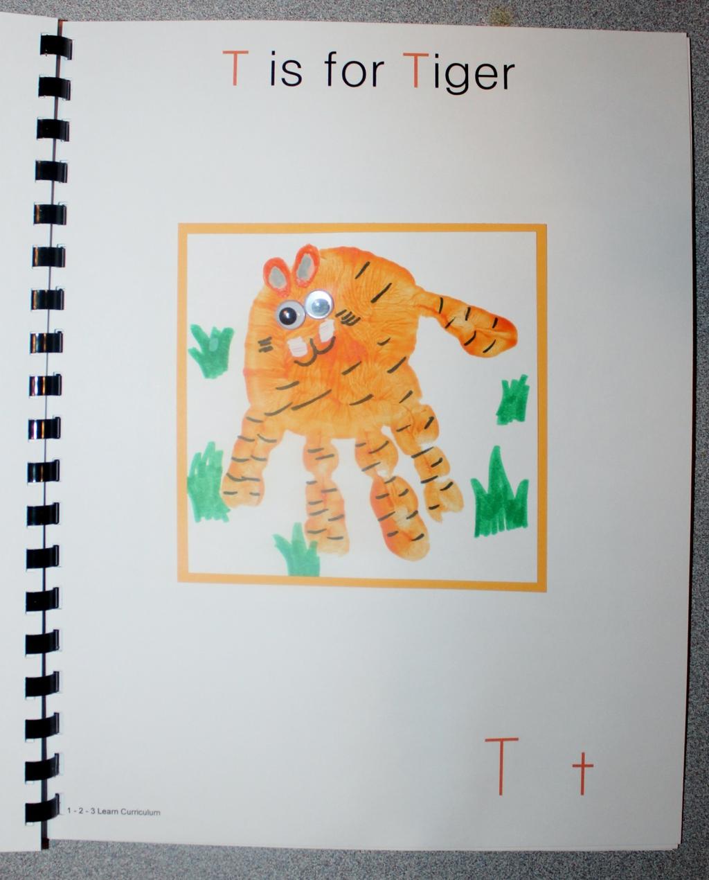 T is for Tiger Paint the child s hand orange and place on white card stock. When dry, trim and attach to orange card stock. Using orange paint, make ears.