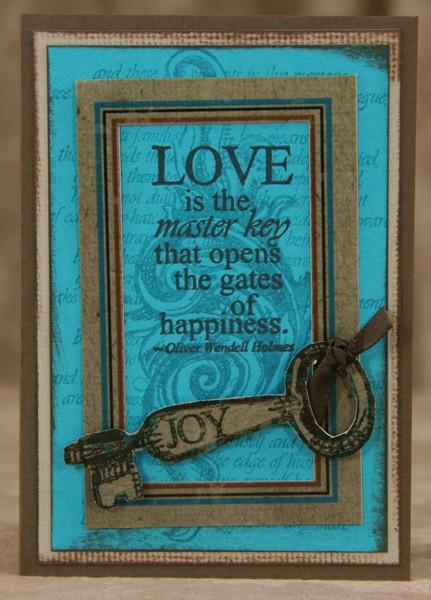 Tie ribbon around the right edge of the frame and center onto the card. Attach the brass key to the upper left corner. Layer the inner image onto the card with foam adhesive.