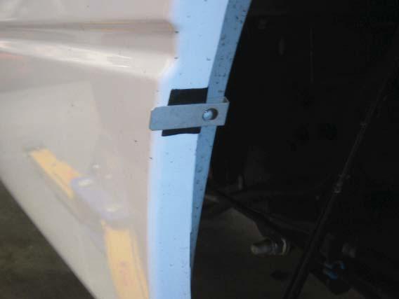 Install a long clip over each of the six black tabs placed on the sheet metal in Step 17.