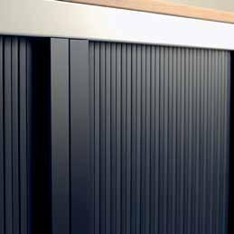 Horizontally sliding shutters in extruded PVC and a lateral compartment to house doors.