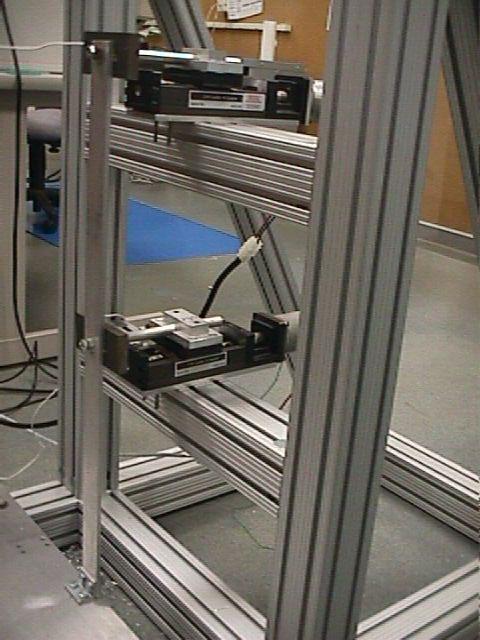 through a reaction wall or gantry frame. This system is envisioned as a low-cost test simulator, which can be readily assembled using existing equipment in typical structural dynamics laboratories.