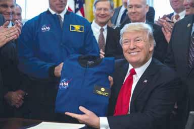 President Donald Trump, receiving a flight jacket on March 21, 2017, after signing the Transition Authorization Act of 2017 at the White House.