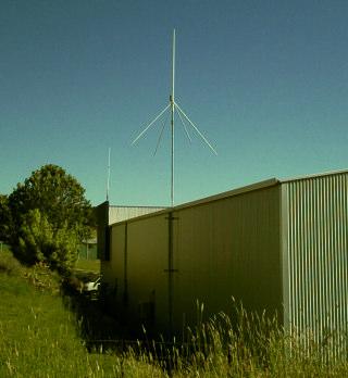 The antenna is a quarter-wave ground plane at 9 meters above ground, approx 3 meters above the factory roof.