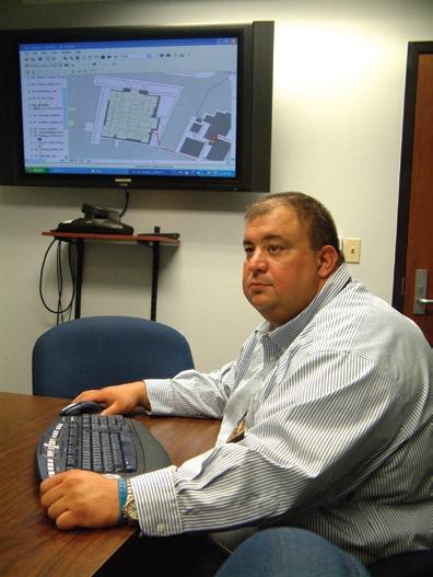 LSU police officer Joe Thompson demonstrates the developing campus GIS in the Command Center conference room.