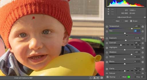 With the shadowed part of the boy s face isolated, the adjustment sliders are being used to correct the tone and color.