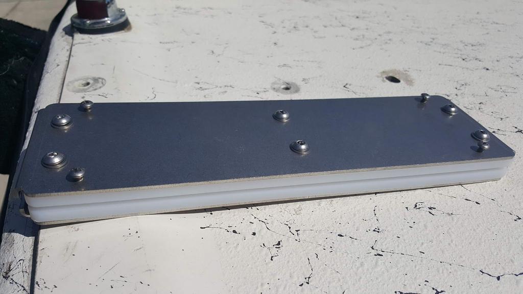 Figure 12. Figure 12 shows the white rail and the two metal plates aligned with the holes you just drilled. Using the ¼-20x2.