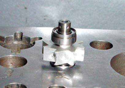 STEP 5 Original Turbine Only: Now place another KaVo bearing face down into Hole #2 of your work block. Now, insert the back button side of the spindle into the bearing as shown at left.