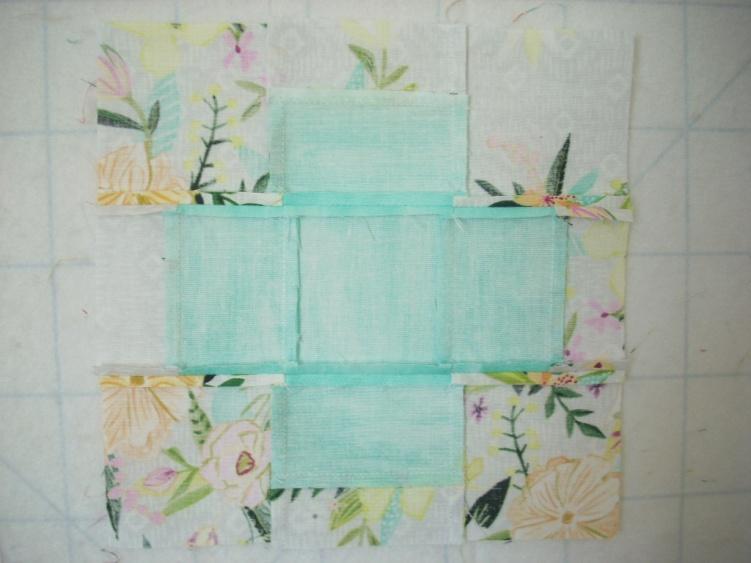 Repeat with remaining rectangles and then sew the squares into rows as pictured above. Next sew the rows together to make the block Press as desired.