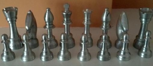 Q. (a) Aluminium chess pieces shown below were commercially produced by the process of die casting.