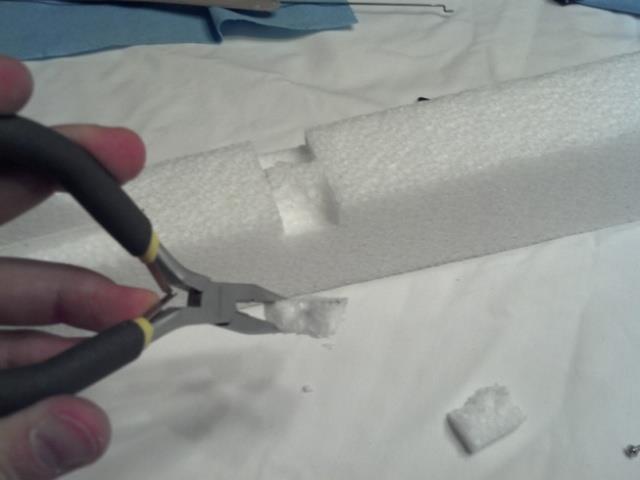 Use a straight edge and razor blade to cut across the fuselage at the front and back
