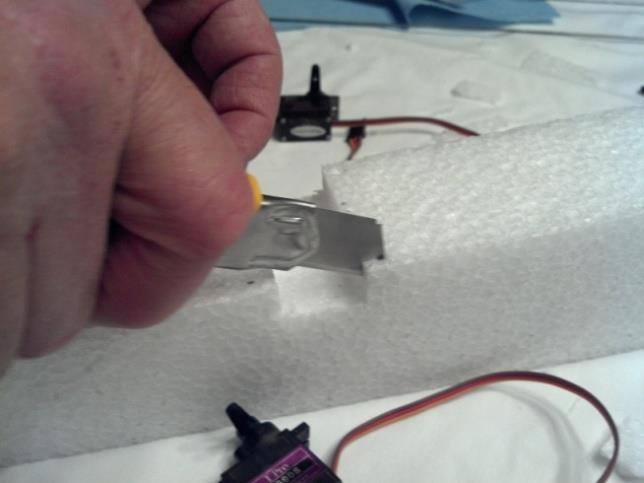 Cut only as deep as you need to for the servos to lay flush with the top of the
