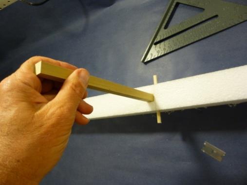 71. Press the sharpened end of the pod in the hole in the fuselage so it extends to the