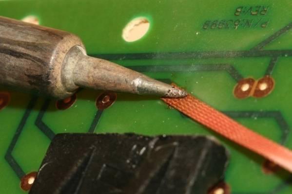 Apply the solder wick and soldering iron to the de-soldered connection.