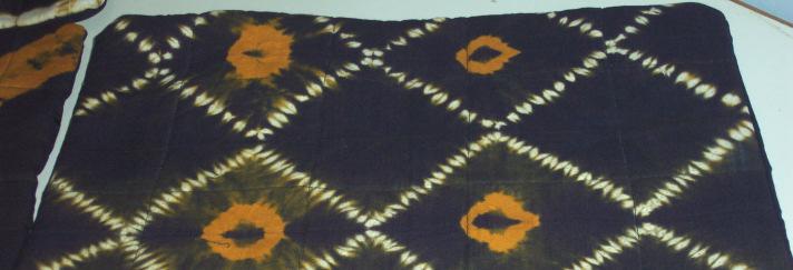 The material with the first set of ties is dyed yellow. There is also a process, mostly followed in Rajasthan of dyeing parts of the material by hand - lipai technique.