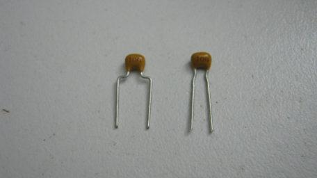 Install the small monolithic capacitors on the main board. Install them flush to the surface of the board.