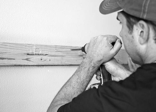 Using a wood stud finder, mark the location of the studs along the level line for the