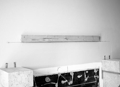 Using the 4" screws provided with your surround, attach the wood mantel ledger to the