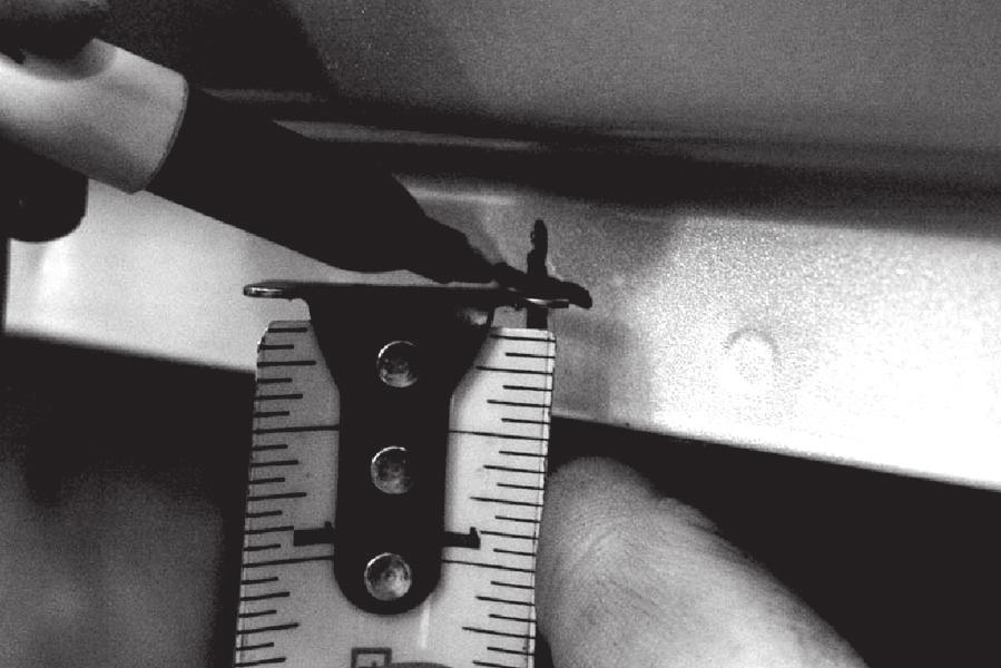 FIGURE 7 Next, measure from the bottom edge of the pinch weld flange, at each vertical