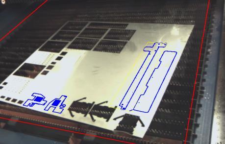 manually place work piece contours on the material on a screen showing a camera image of the machine interior.