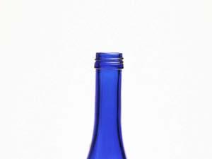 Here is an example of using a camera flash to take a picture of a blue bottle against a white background.