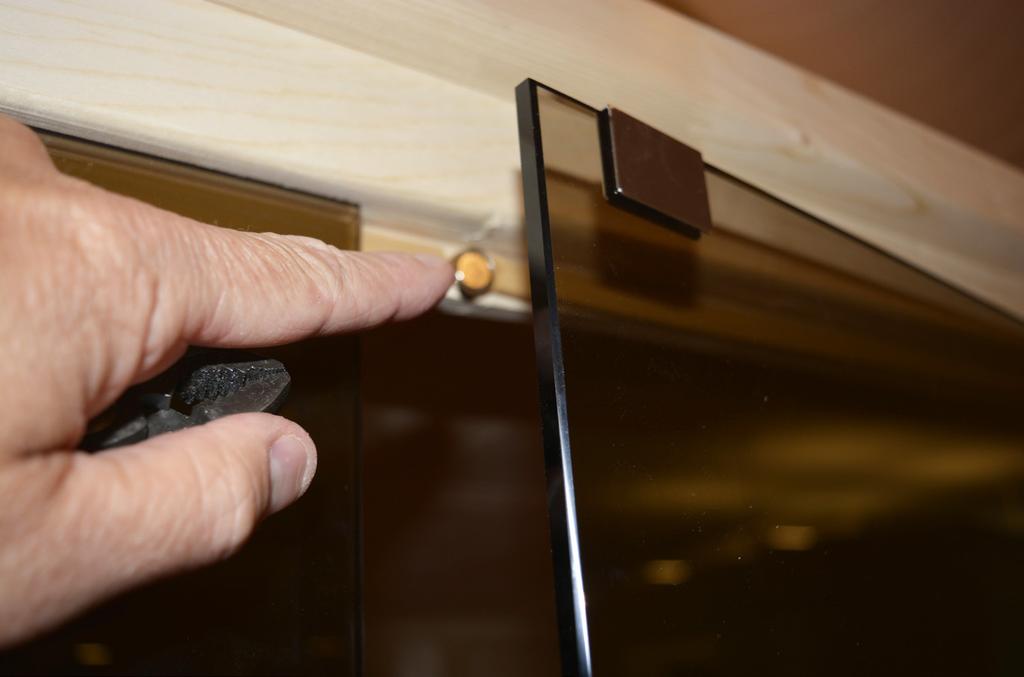 STEP 33 - On the header above the door, peel back some of the sealing strip and find the pre-drilled