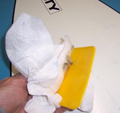 Gently heating the pad and peeling it up is a good way to start. A plastic paint scraper or squeegee works well too.
